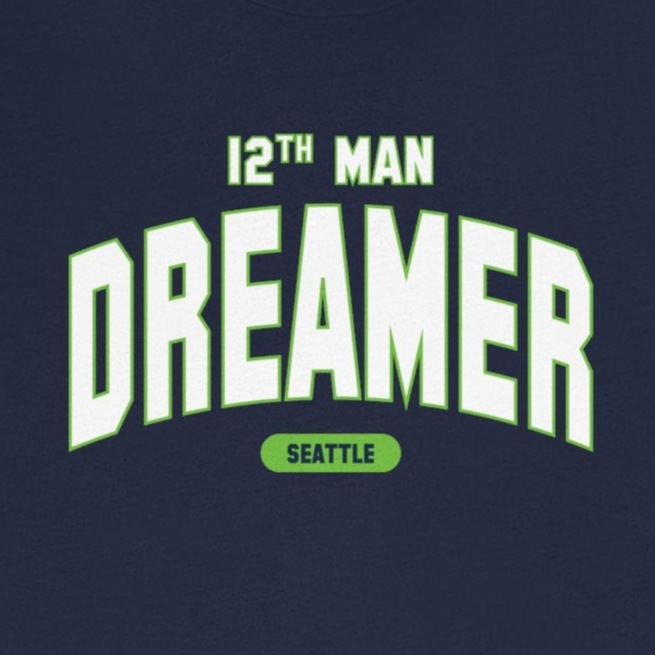 Navy blue t-shirt with '12th Man Dreamer Seattle' text on a white background